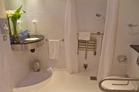 a white bathroom with a sink and a shower at Holiday Inn Express Campo de Gibraltar-Barrios, an IHG Hotel in Los Barrios