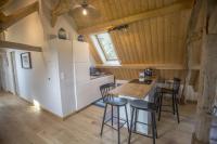 a kitchen and dining room with a table and chairs at Domaine de la Valaine in Étretat