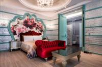 a bedroom with a large bed and a red chair at Icloud Luxury Resort &amp; Hotel in Taichung