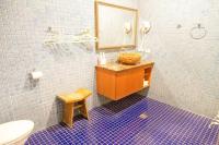 a bathroom with a sink and a mirror and a toilet at Golden Ocean Azure Hotel in Kenting
