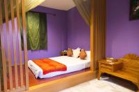 a purple bedroom with a bed and a wooden table at Golden Ocean Azure Hotel in Kenting
