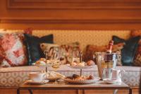 a table with wine glasses and plates of food at Hôtel de l&#39;Abbaye in Paris