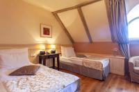 a hotel room with two beds and a window at Boutique Hotel Nautilus in Tábor