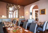 a dining room with tables and chairs and a mirror at Boutique Hotel Nautilus in Tábor