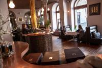 a restaurant with a bar in the middle of a room at Boutique Hotel Nautilus in Tábor
