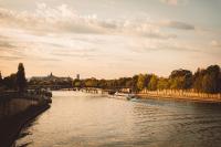 a river with a bridge and boats on it at Hôtel de l&#39;Abbaye in Paris