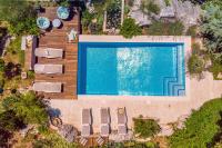 an overhead view of a swimming pool with loungers and chairs at Villa Tajina Kuca in Žeževica