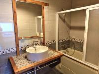 a bathroom with a sink and a shower and a tub at Shiyai Taoyuan in Ren&#39;ai