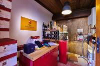 a store with a counter with bottles of wine at Pension Kral in Rust