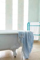 a bathroom with a bath tub with a towel on it at Hotel Punta Sur in Tarifa