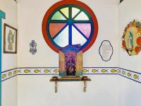 a room with a stained glass window on a wall at Pousada São Francisco in Cumuruxatiba