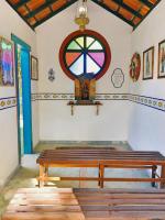 a room with a bench and a stained glass window at Pousada São Francisco in Cumuruxatiba
