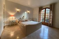 a bedroom with a large bed and a window at Villa Roka in Six-Fours-les-Plages