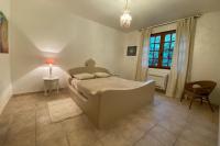 a bedroom with a bed and a table and a window at Villa Roka in Six-Fours-les-Plages