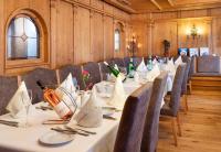 a dining room with a long table with wine bottles at Seiblishof Superior Hotel Ischgl in Ischgl