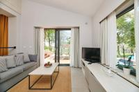 ein Wohnzimmer mit Couch und Fernseher in der Unterkunft Villas Bellevue Plava Laguna in Poreč