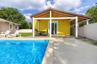 a pool in front of a house with a pavilion at Beatiful families oriented villa Trusina with pool immersed in the nature near the town in Valtura