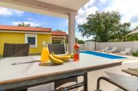 a table with bananas and a bottle of wine on it at Beatiful families oriented villa Trusina with pool immersed in the nature near the town in Valtura