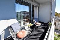 a balcony with chairs and a table on a balcony at Romana Serena Sunset in Vrsar