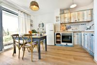 a kitchen with a table and chairs and a refrigerator at Romana Serena Sunset in Vrsar