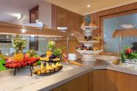 a buffet with three plates of fruit on a counter at Geographotel Paris-Roissy CDG Airport in Le Mesnil-Amelot