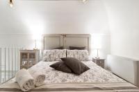 A bed or beds in a room at Palazzo Mandurino luxury relais