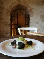 ein weißer Teller mit Brokkoli auf einem Tisch in der Unterkunft Villa Anitori Prestige Relais & Spa in Loro Piceno