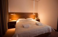 Posteľ alebo postele v izbe v ubytovaní Hotel Rubin