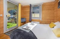 a bedroom with a large bed and a window at Le Paradis 25 Apartment - Chamonix All Year in Chamonix