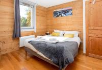 a bedroom with a bed in a wooden room at Le Paradis 25 Apartment - Chamonix All Year in Chamonix
