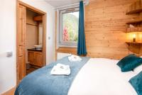 a bedroom with a bed with two towels on it at Le Paradis 25 Apartment - Chamonix All Year in Chamonix