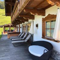 a row of chairs sitting on a deck at Romantiksuite in Alpbach