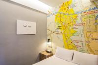 a bedroom with a bed and a map on the wall at 仁愛小公館-市區近東大門 in Hualien City