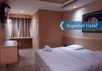 a hotel room with a bed and a sign that says superior casino at Biss Inn Hotel in Goiânia