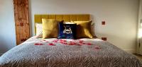 a bed with a dog pillow and red flowers on it at Angel Townhouse in London