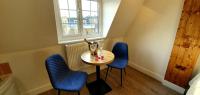 a small table and two blue chairs in a room at Angel Townhouse in London