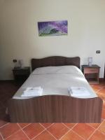A bed or beds in a room at Le Coste Affittacamere