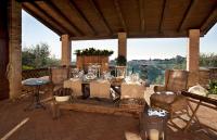 a patio with a table and chairs with a view at Agriturismo La Vigna di Sarah in Vittorio Veneto