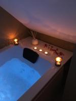 a bathroom with a tub with lights and candles at Urban Spa Cosy Zen in Troyes