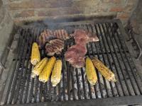 a group of corn and meat on a grill at Eco-Cabañas Altozano Nimaima in Nimaima