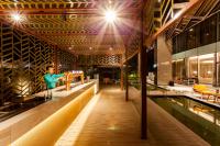a woman standing at a bar in a building at Crowne Plaza Vientiane by IHG in Vientiane