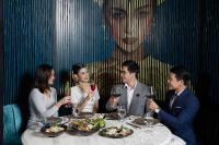 a group of people sitting around a table with wine glasses at Crowne Plaza Vientiane by IHG in Vientiane