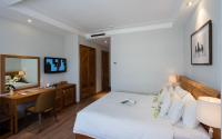 a bedroom with a bed and a desk and a computer at Silverland Yen Hotel in Ho Chi Minh City
