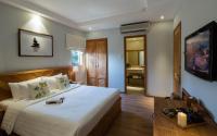 a bedroom with a large bed and a bathroom at Silverland Yen Hotel in Ho Chi Minh City