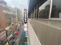 a view of a street in a city with buildings at Hey Bear Capsule Hotel in Taipei