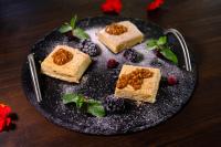 a plate of food with dessert on a table at GRAND OTRADA Hotel Resort & SPA in Odesa