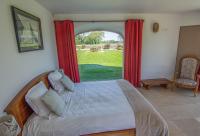 a bedroom with a bed and a large window at Domaine de kerbillec in Theix