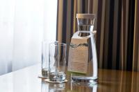 a bottle and a glass on a table at Holiday Inn Vienna City by IHG in Vienna