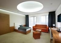 a hotel room with a bed and a couch at Hotel Vitality in Vendryně