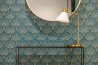 a lamp on a wall with a blue and gold wallpaper at NOCNOC - Le Michelangelo in Lyon